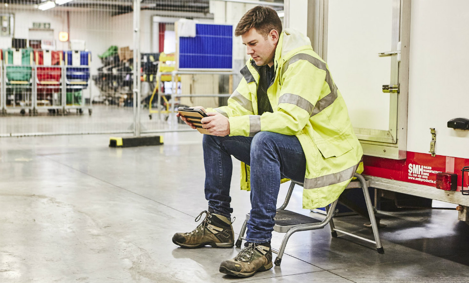 Site auditor looking at data on an ipad while sitting down